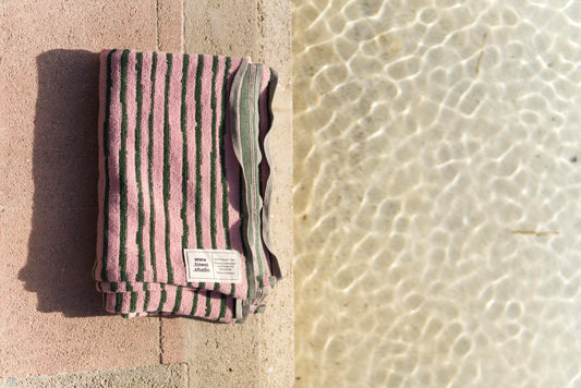 Striped pink and green towel for the pool and beach